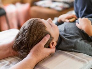 A person lying comfortably on their side in bed with a relaxed facial expression, suggesting restful sleep.